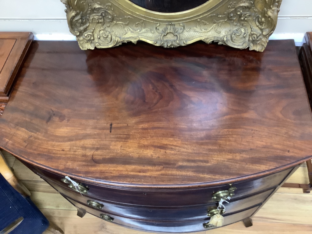 A late Georgian bow-fronted mahogany chest with brushing slide, width 94cm, depth 54cm, height 88cm